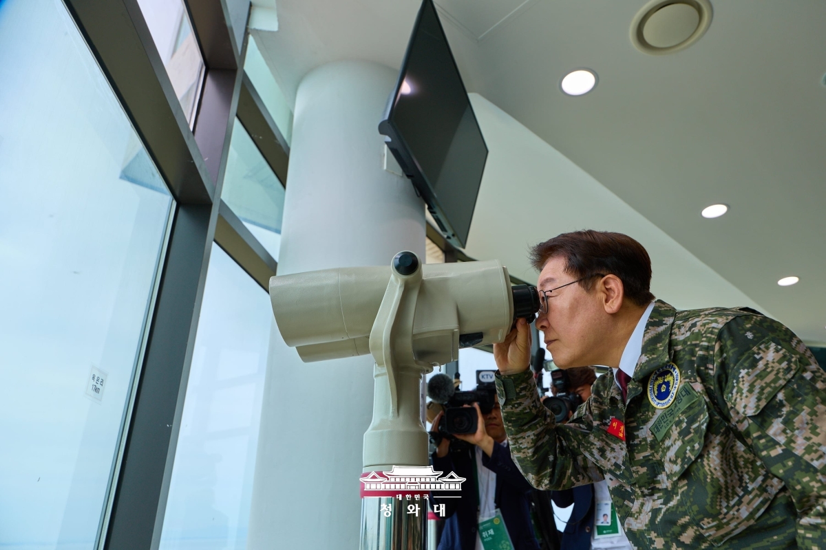 이재명 대통령이 24일 최접적 인천 옹진군 해병대 연평부대를 찾아 평화전망대에서 망원경으로 북한 쪽을 살피고 있다. [사진출처=청와대]