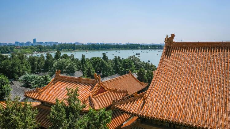 자금성 근처에서 바라본 붉은 기와지붕과 그 너머로 펼쳐진 호수 전경이 베이징의 고궁과 자연을 함께 담아내는 장면