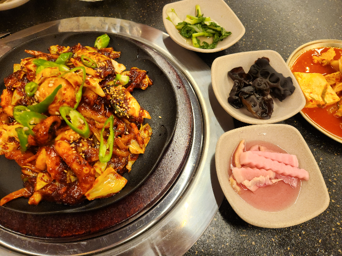 A plate of stir-fried octopus is on the table.