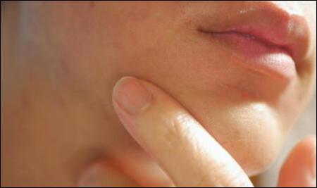 얼굴을 만지고 있는 손