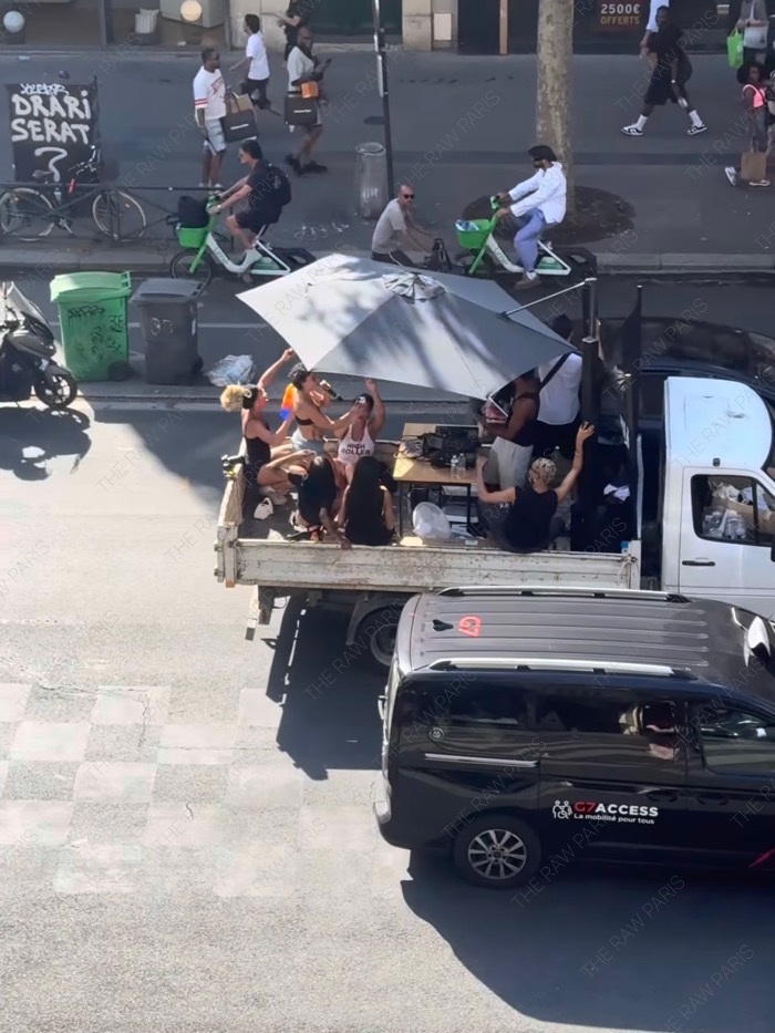 DJs performing on the back of a white truck during Fete de la Musique outdoor street party in Paris⁠