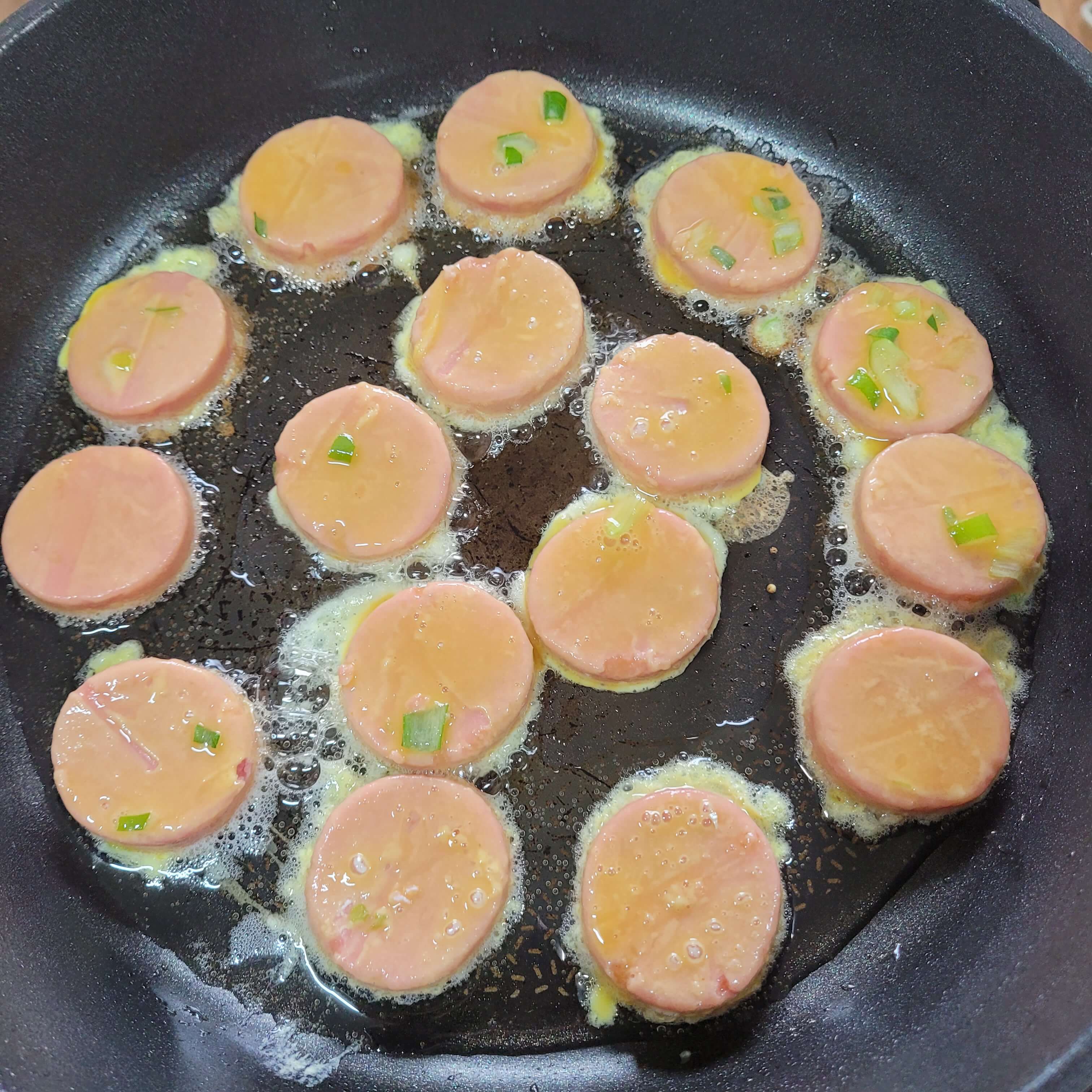 프라이팬에 분홍소시지를 올려주세요.