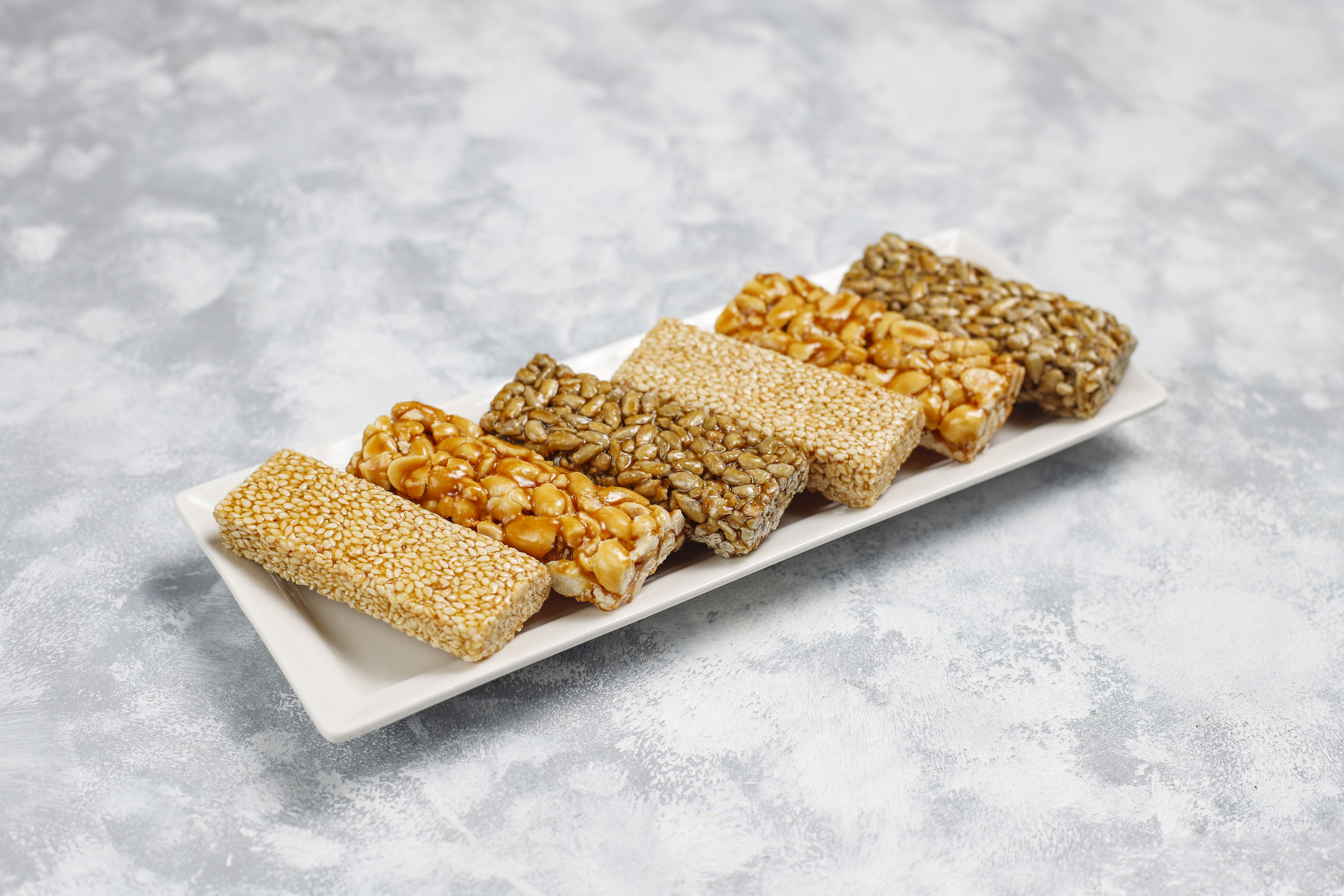granola-bar-healthy-sweet-dessert-snack-sesame-peanut-sunflower-honey-gozinaki-is-georgian-national-food-oriental-sweet-top-view-concrete