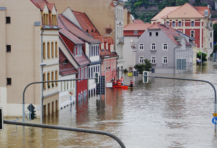flooded city, with people in a boat