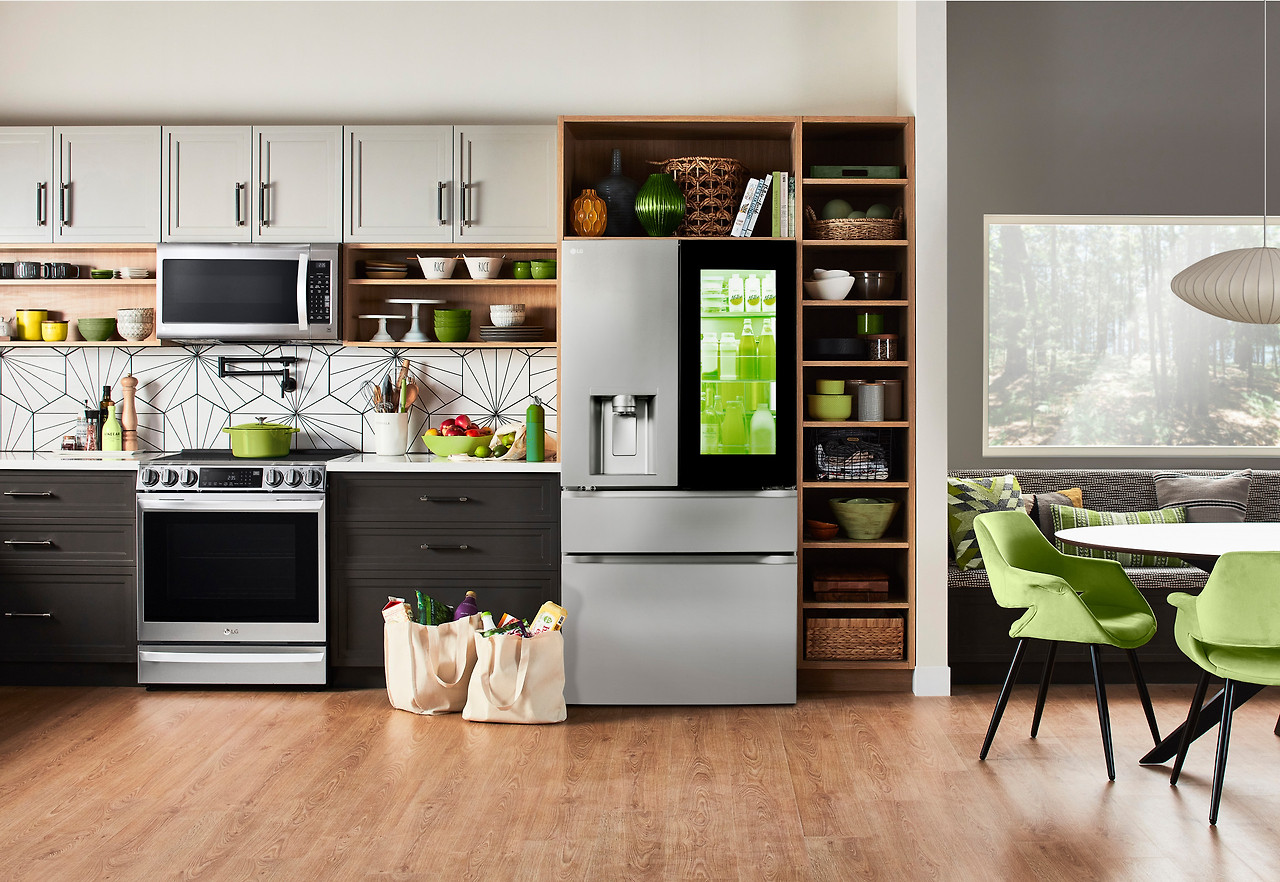 Modern kitchen with various refrigerator models and discount tags on sale during the 2024 appliance sale season