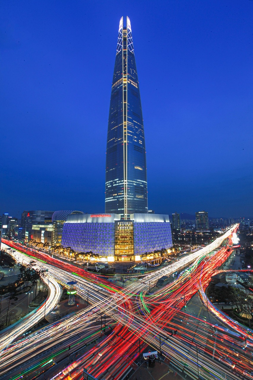 Close-up night view of Lotte World Tower in Seoul illuminated against the dark blue sky