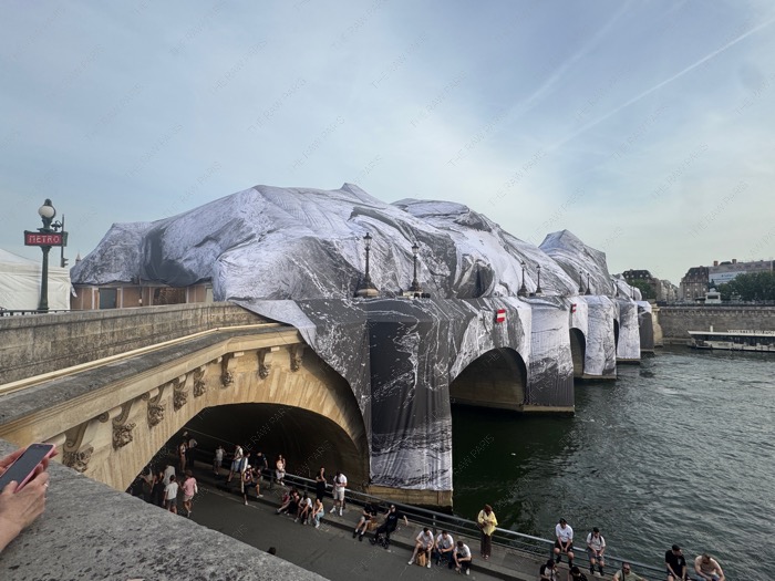 The historic Pont Neuf bridge in Paris wrapped in a giant monumental cave-like art installation by JR ❘ Le pont historique du Pont-Neuf &agrave; Paris envelopp&eacute; dans une installation artistique g&eacute;ante de JR en forme de grotte monumentale⁠