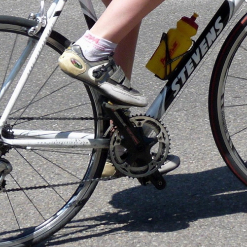 Close up view of clipless pedal system with cycling shoe cleat properly engaged
