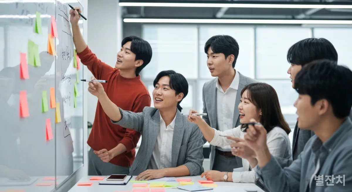 화이트보드 앞에서 아이디어를 나누는 한국인 스타트업 팀원들