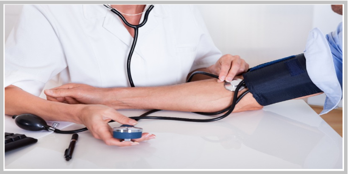 진료실에서 의료진이 환자의 팔에 수은 혈압계를 이용해 혈압을 측정하는 장면