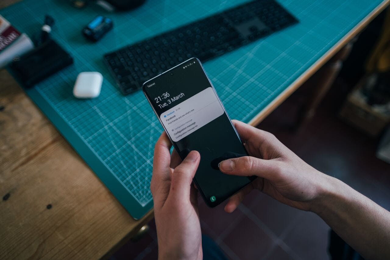 hand touching mobile phone