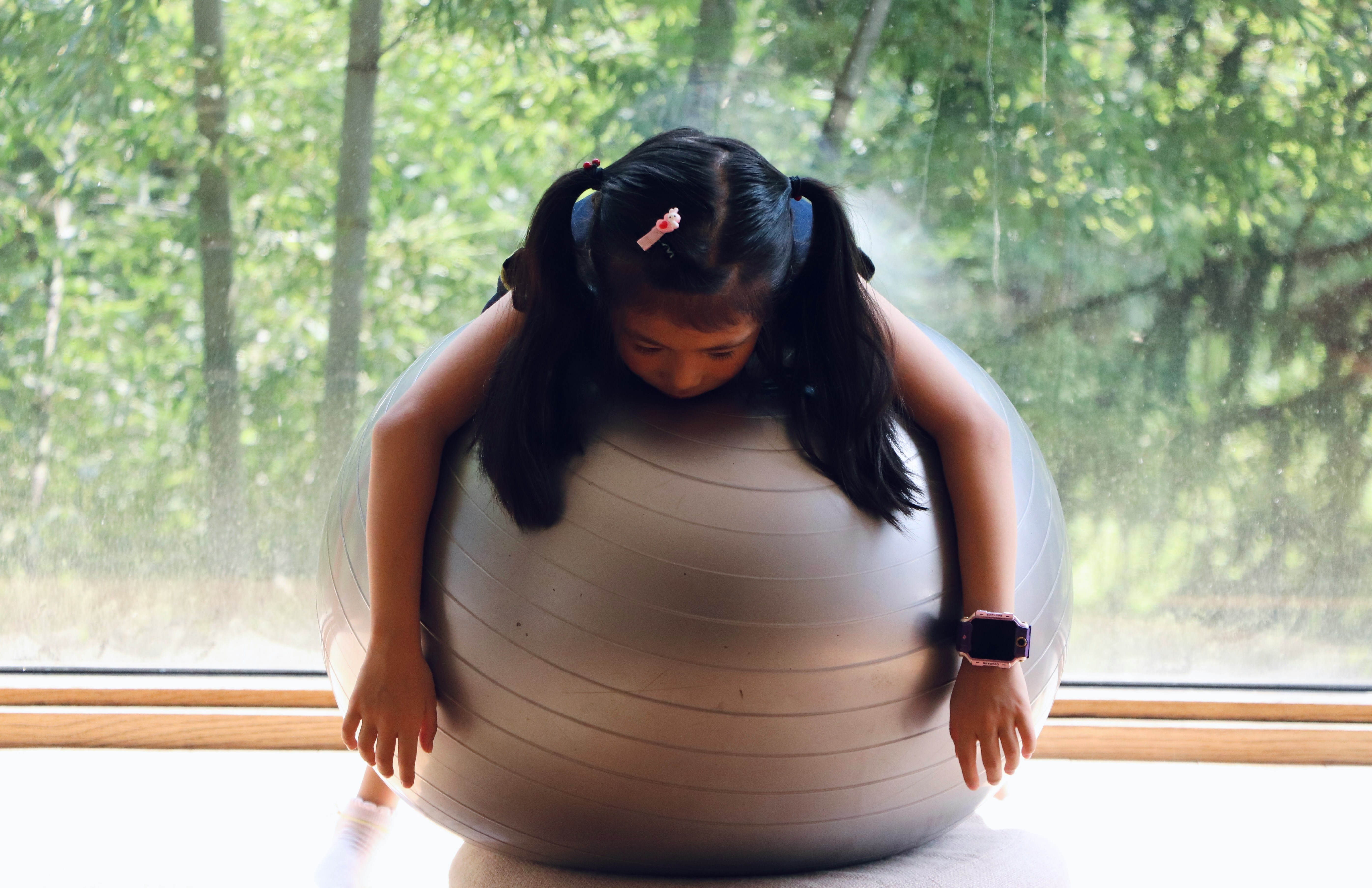 운동볼 위에 지친 듯 엎드린 소녀, 대사 저하로 피곤한 몸을 표현한 이미지