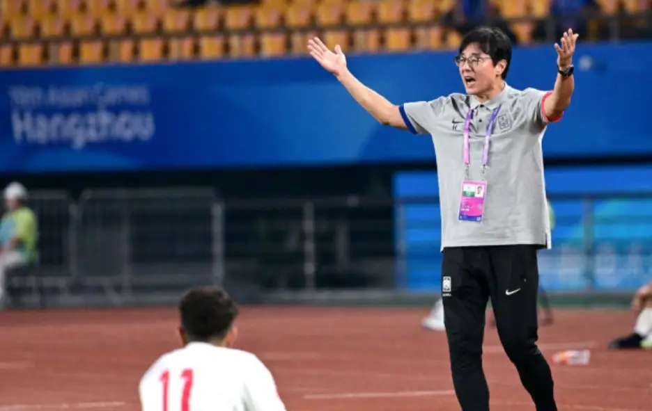 황선홍- 축구장 흰색점퍼 검은색 긴바지 분홍색 목걸이 형 이름표를 목에걸고 두손을 높이든채 소리지르고 있는 황선홍 감독