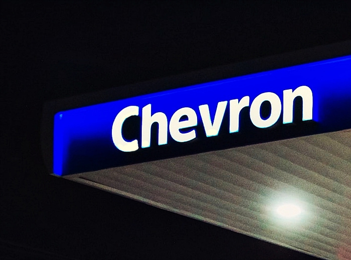 캄캄한-밤에-흰색-밝은-불빛의-쉐브론-간판이-보이는-주유소-지붕