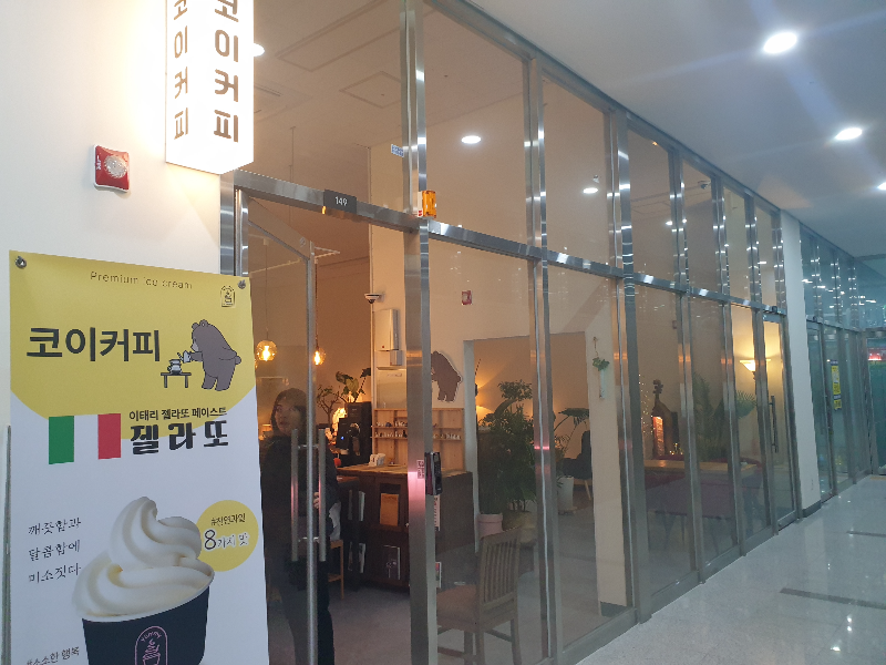 실버 프레임으로 된 코이커피 외곤. 은은한 조명이 비춰진다.