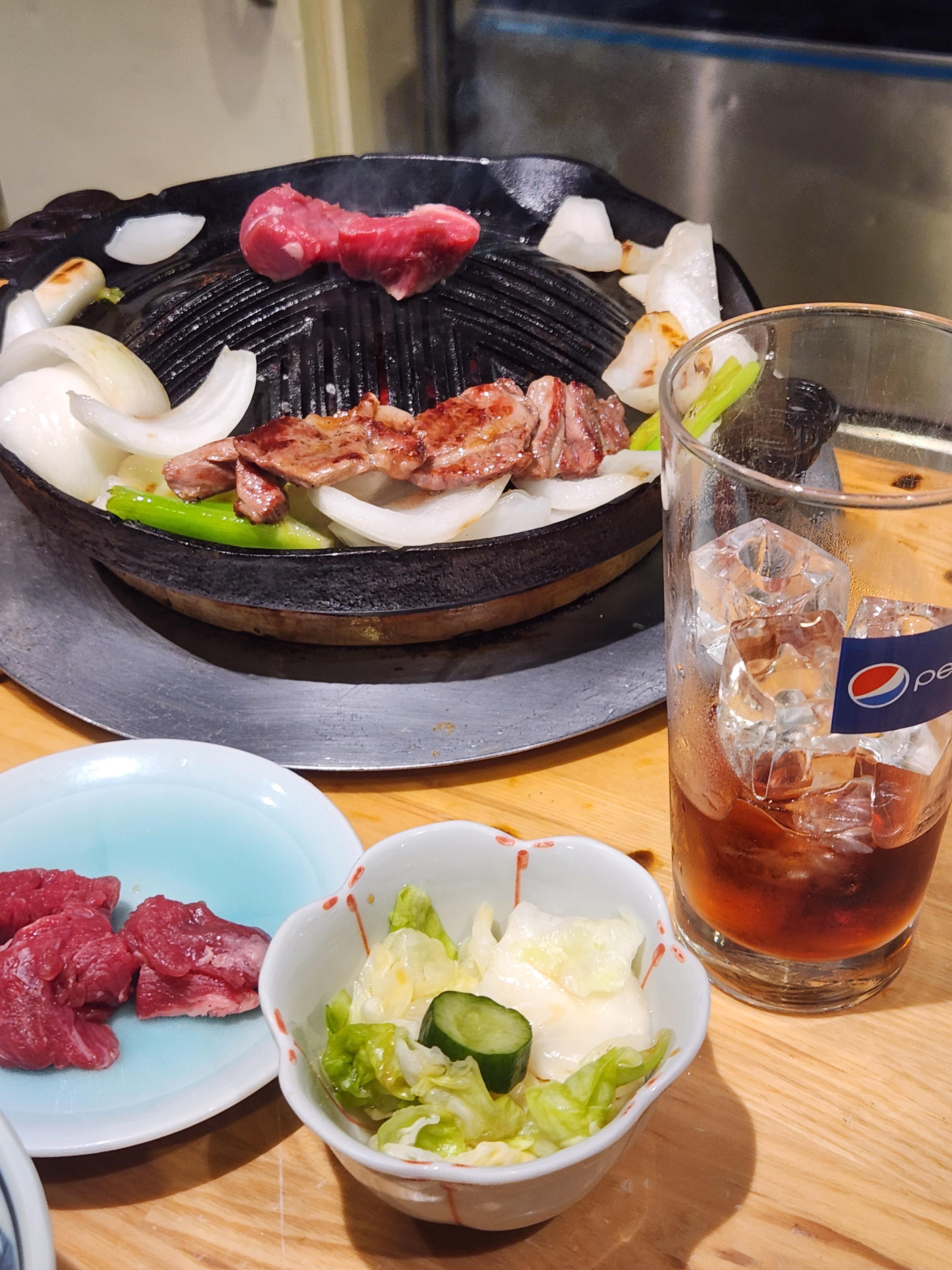 먹음직스럽게 고기가 구워지고 잇으며, 대파와 양파를 함께 굽고있다