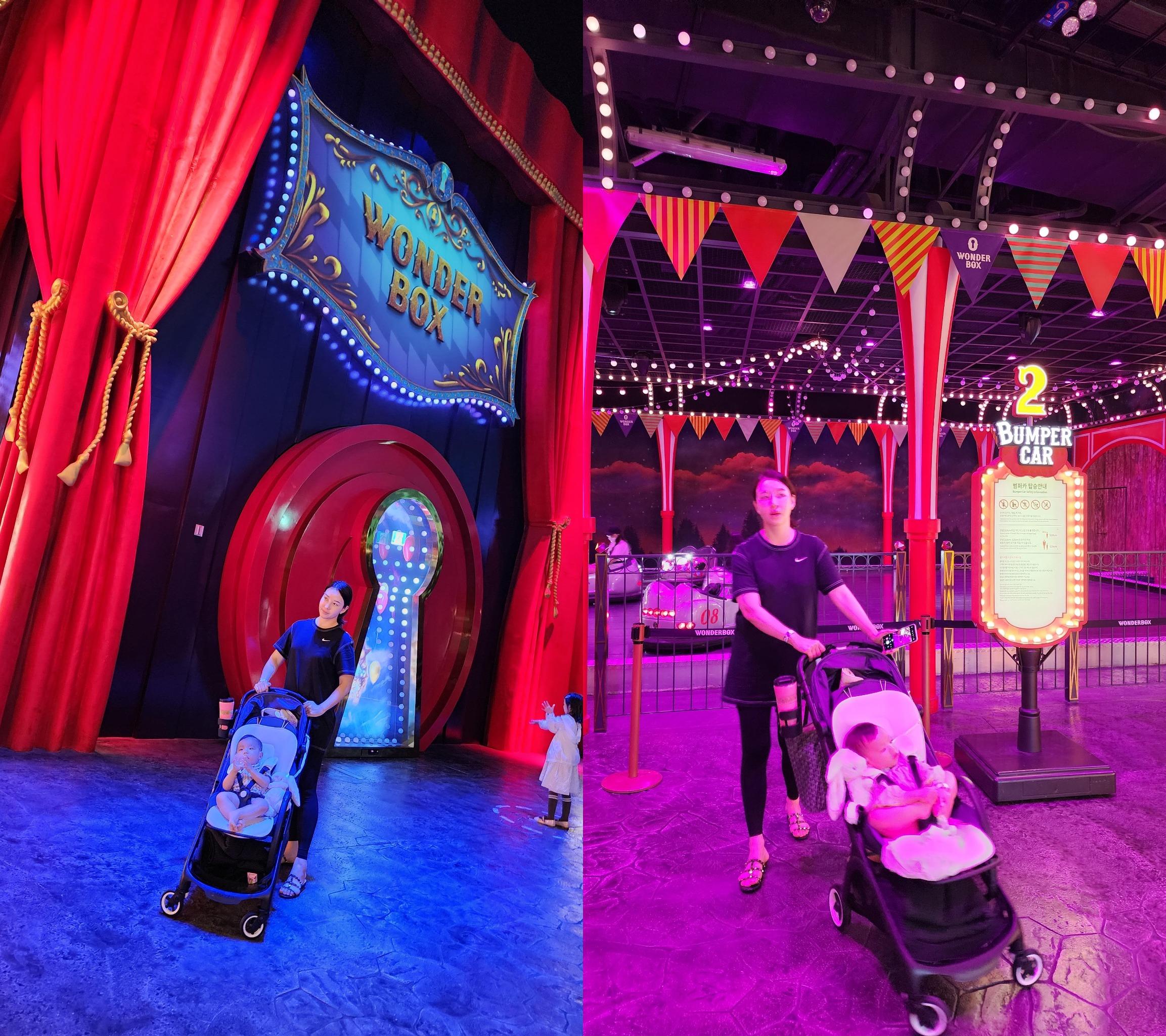 파라다이스시티 원더박스 입구와 범퍼카 구역에서 유모차를 끄는 엄마와 아기의 모습. 실내 테마파크의 화려한 조명과 가족 나들이의 따뜻한 분위기가 느껴지는 장면.