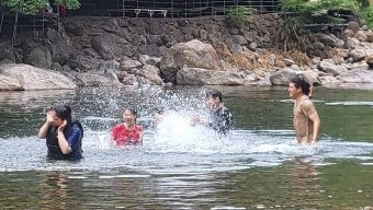 허리-높이의-계곡물에서-가족들이-물장구치며-노는-모습