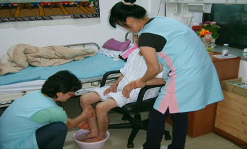 호스피스자원봉사자가 말기암환자의 발을 씻겨드리는 모습