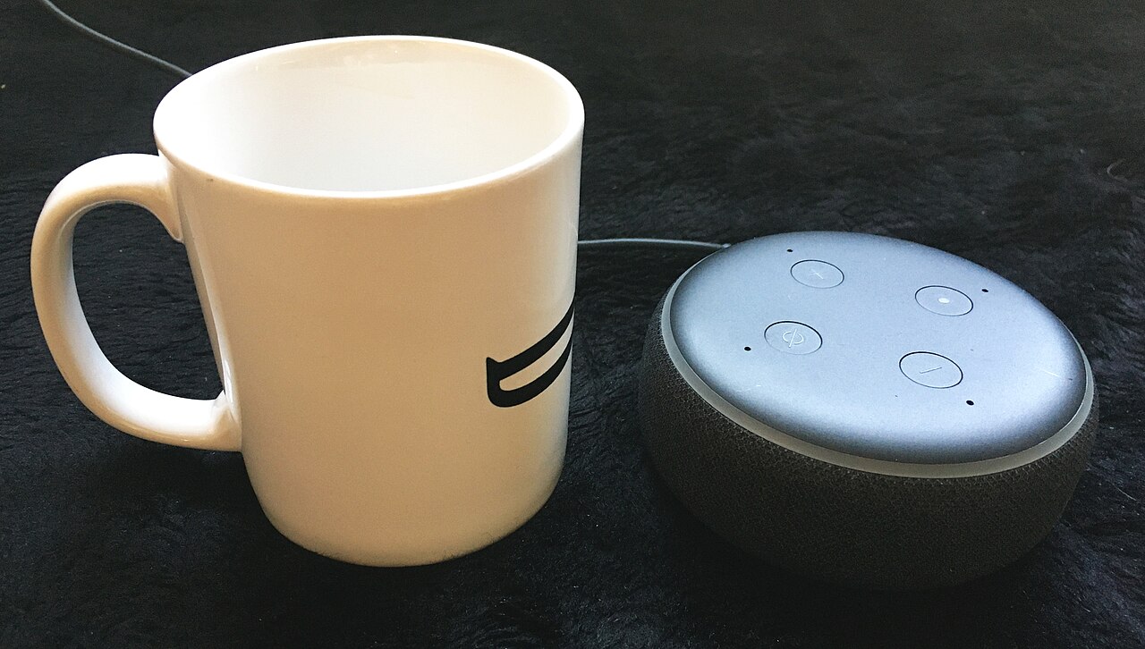 Amazon Echo Dot (virtual digital assistant) with normal coffee mug as size comparison