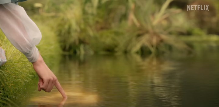 연못에손가락을펴고있는여성