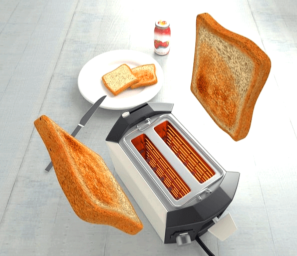 토스트기에서 2개의 갈색이 될 때까지 잘 구워진 토스트가 위로 솟아오르고 있다. 뒤에 한얀 접시에도 2개의 토스트가 있다.