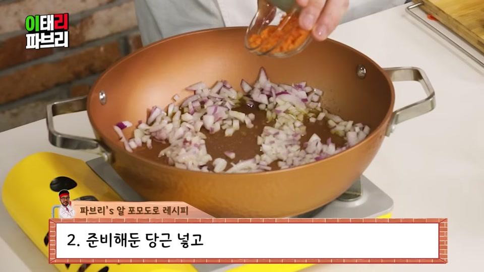 팬에 양파와 당근을 넣고 볶는 장면