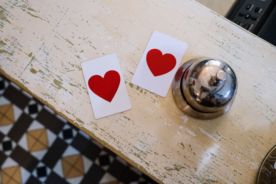 Two heart cards and a bell placed on a vintage counter. Perfect for romance themes.