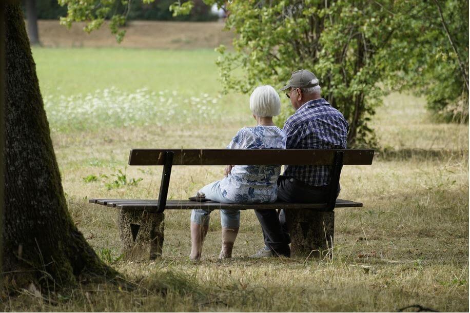 노령화 시대에 벤치에 앉아 있는 노부부