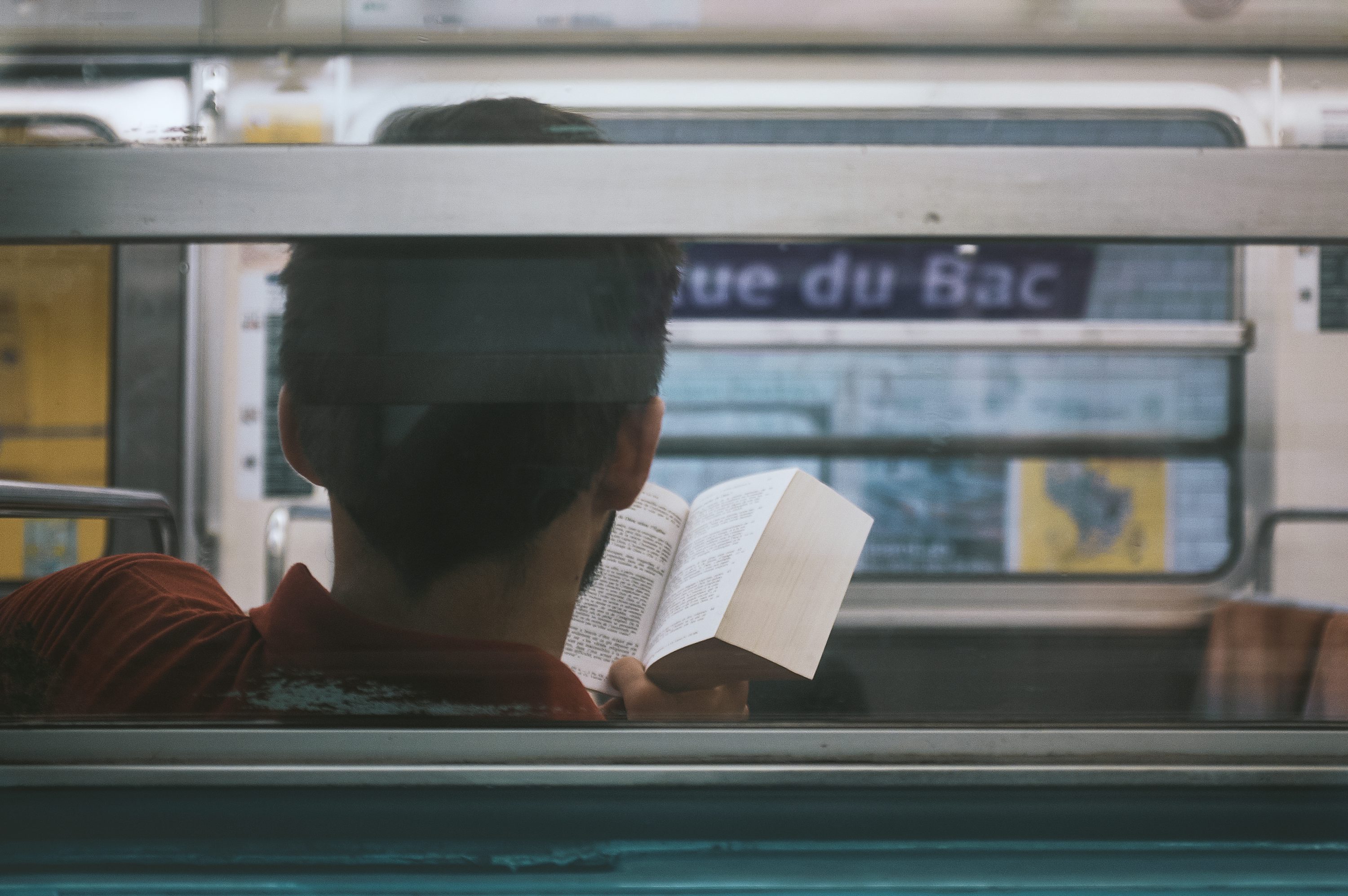 man reading on subway