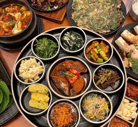 Korean food with side dishes (banchan) and unlimited refills in a traditional meal