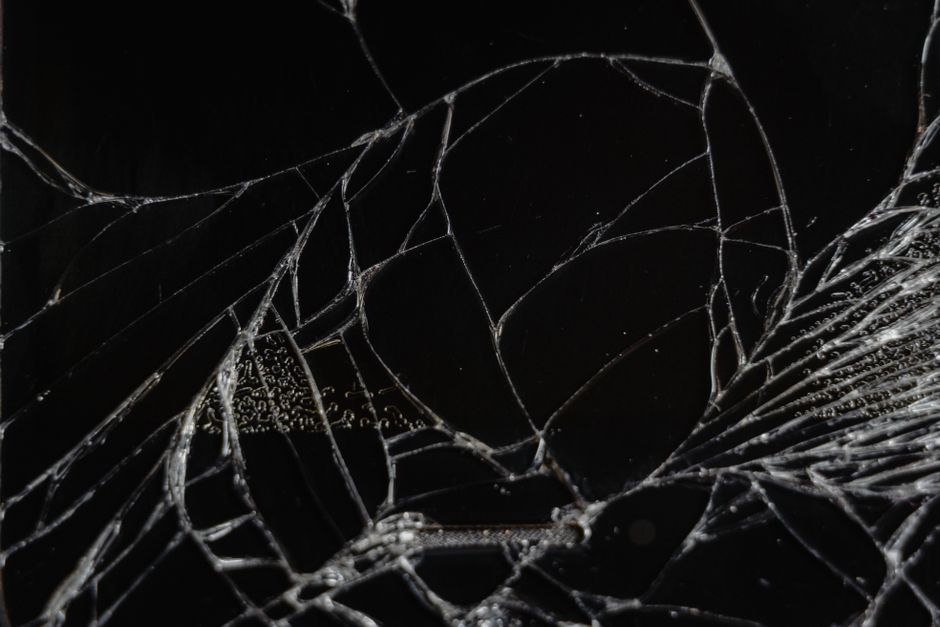 Close-up view of shattered glass showing delicate fragments and patterns.