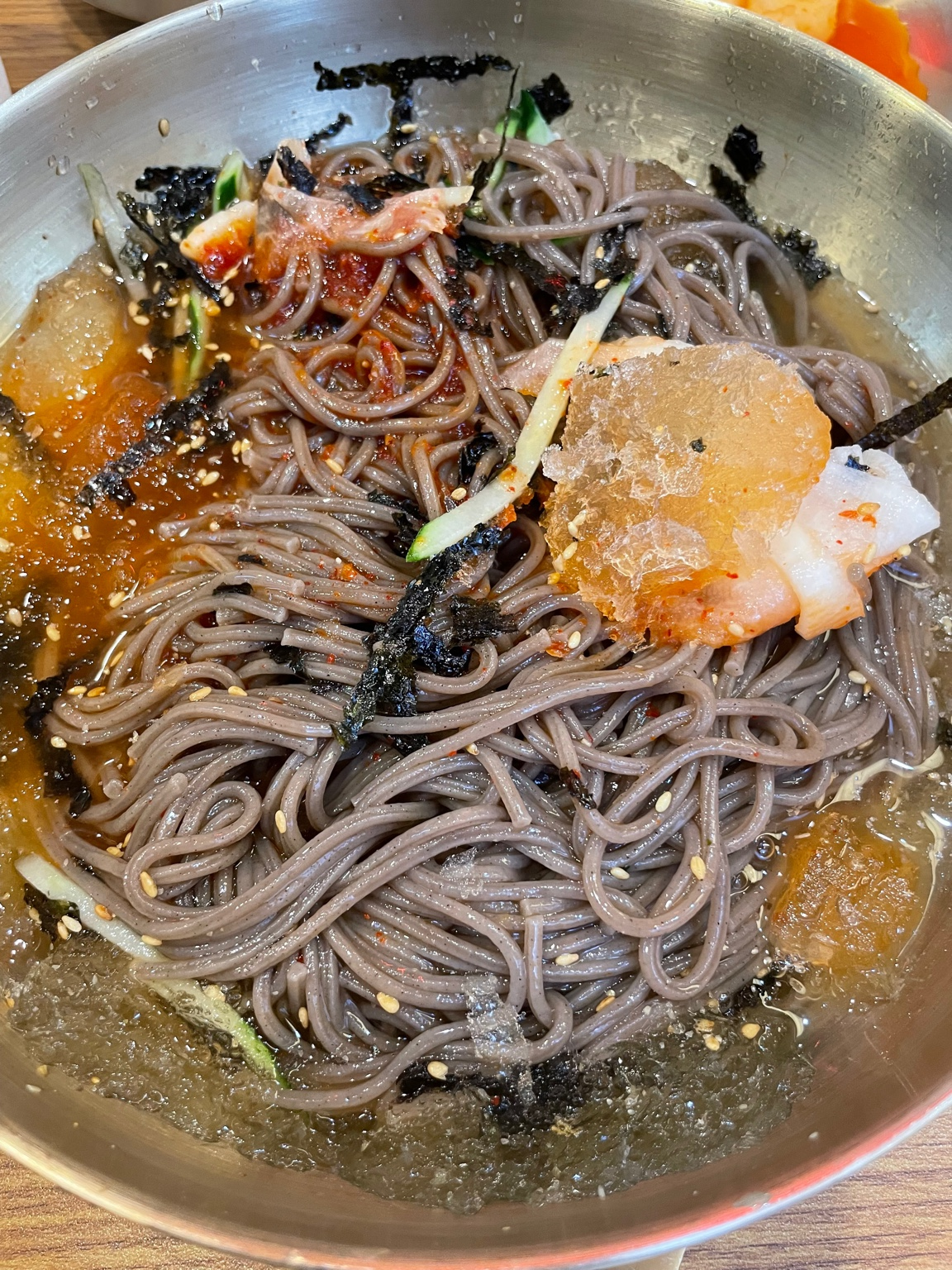 Makguksu in icy broth with cucumber and sesame seeds