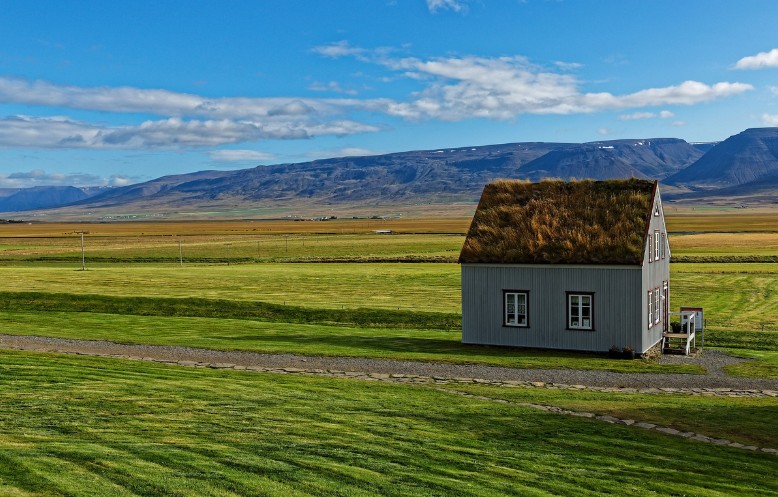 a small rural house in a wide open field