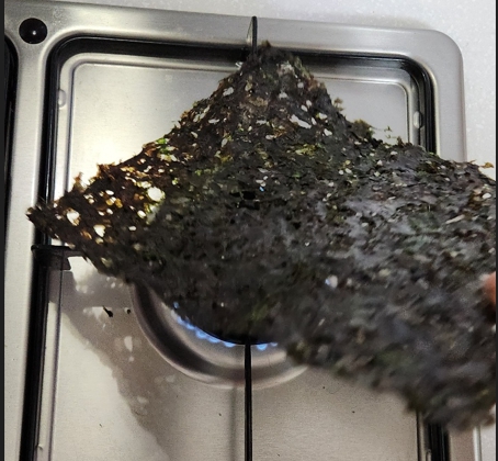 곱창김을 먹을 수 있게 준비하는 과정으로 약불에 굽고 있는 곱창김 사진입니다.