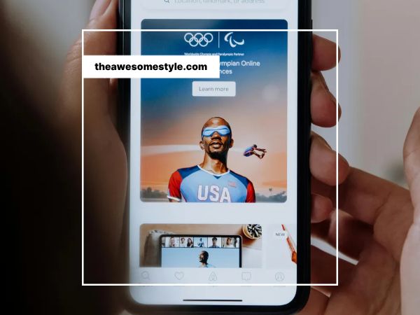 올림픽 광고가 나오는 모바일폰을 들고 있는 사람