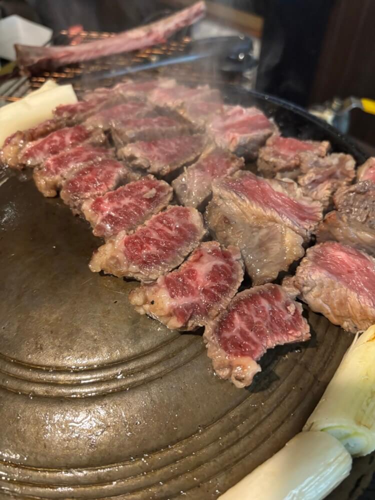 불판 위에 한입 사이즈 잘라 놓아진 고기 