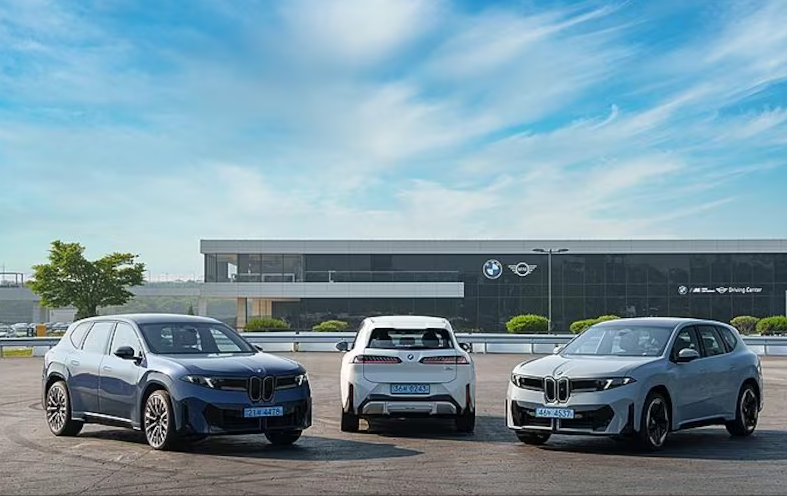 Split view showing the vintage 1960s BMW 1500 and the futuristic 2026 BMW Neue Klasse electric vehicle.
