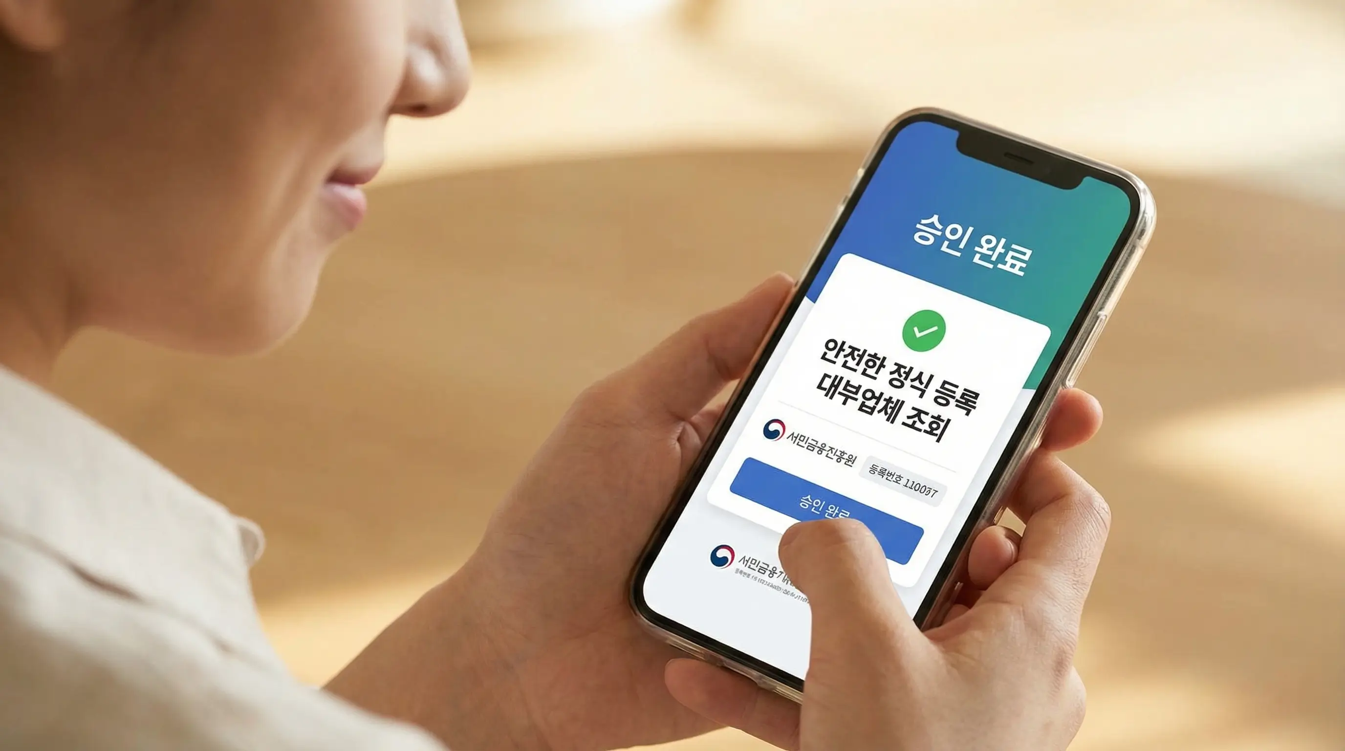 스마트폰으로 안전한 정식 등록 대부업체 조회를 마치고 승인 완료 화면을 보며 안도하는 손의 클로즈업