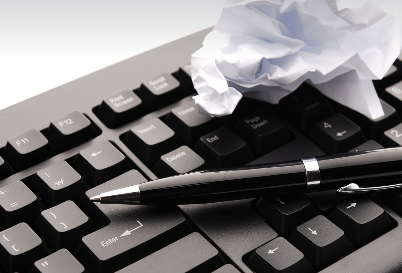 keyboard, pen, and scrapped paper