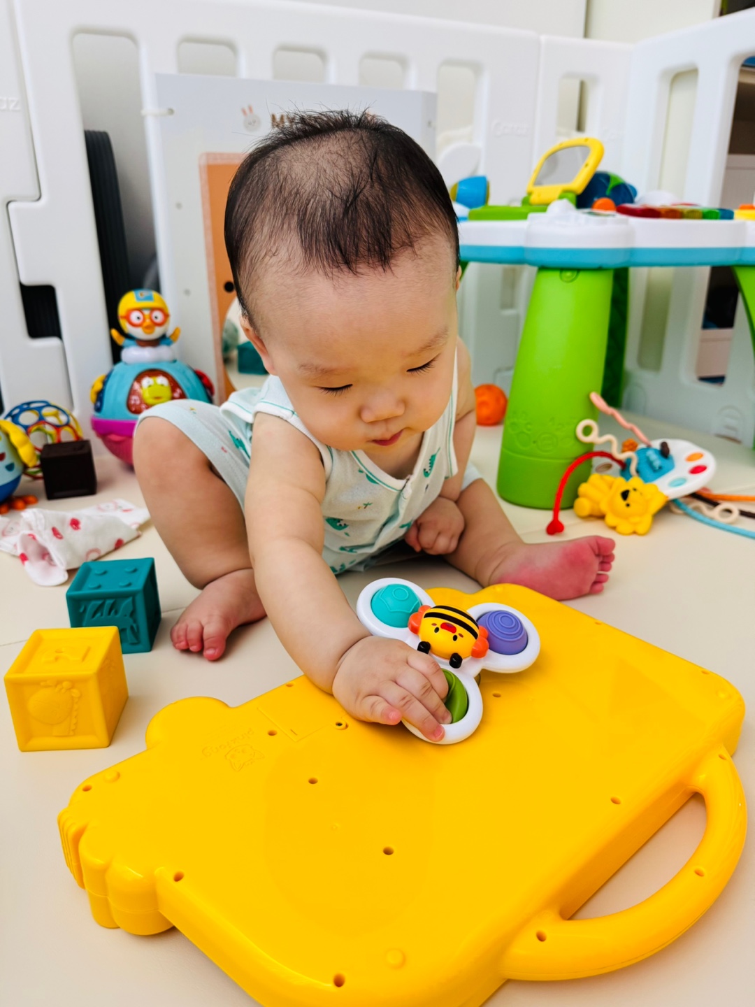 집중해서 스피너를 돌려보며 관찰하는 9개월 아기