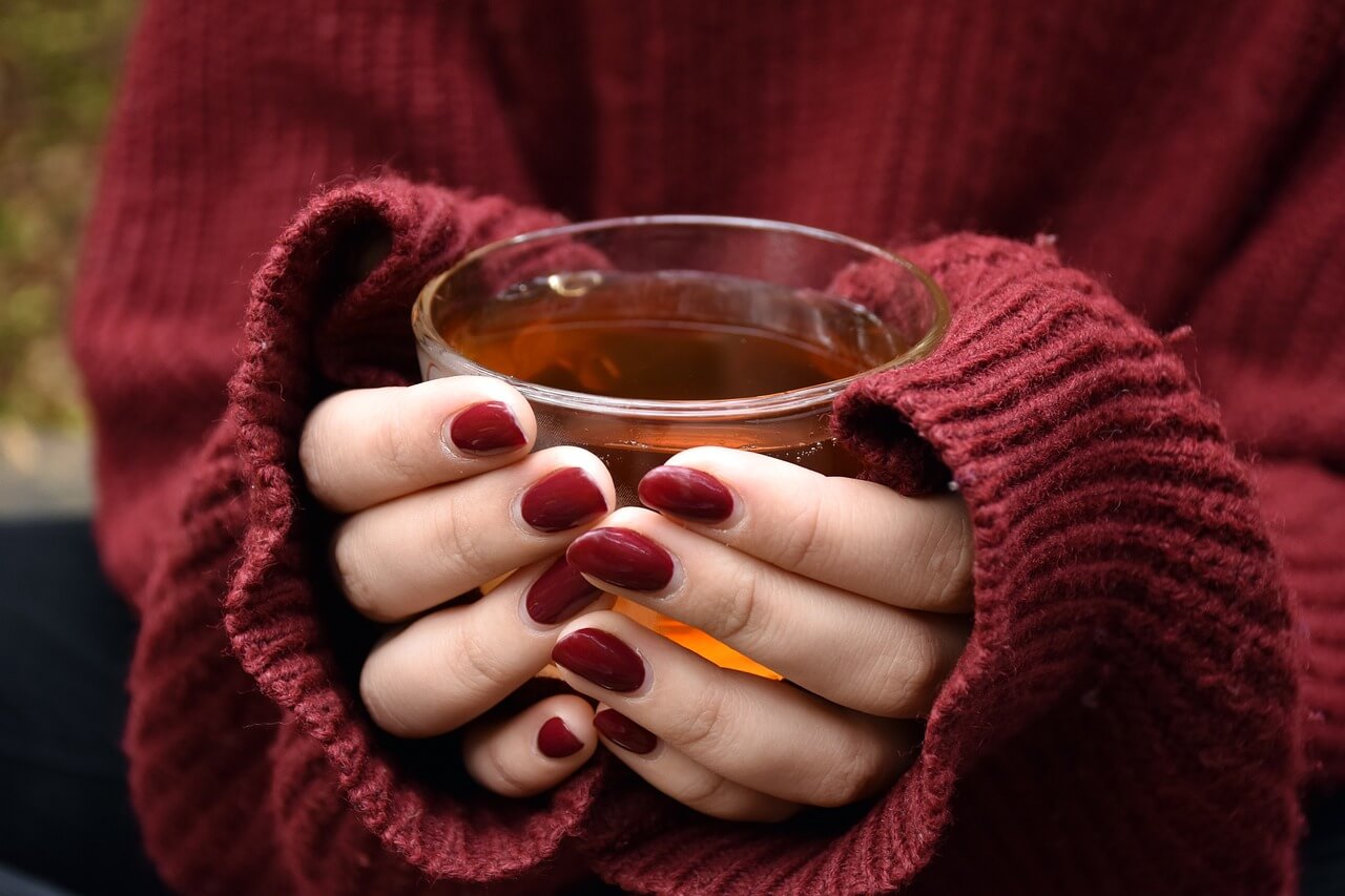 one woman is holding a hot tea