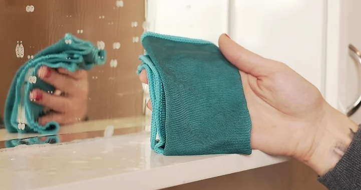 극세사 천으로 거울을 닦는다