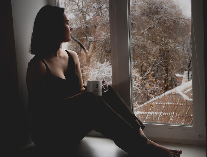 창문을 바라보며 우울해 하는 사진