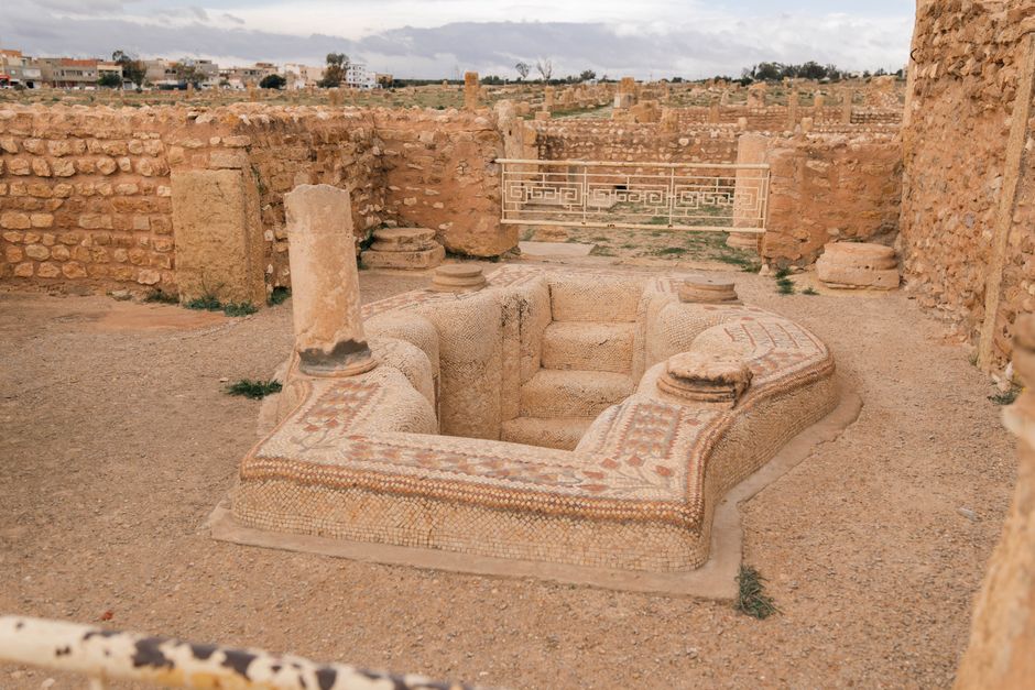 Explore ancient Roman ruins featuring intricate mosaics in Tunisia, capturing historical architecture and culture.