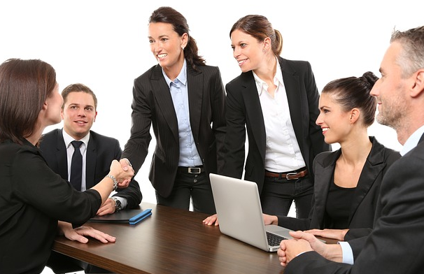 Shaking hands at a business meeting and making an agreement.