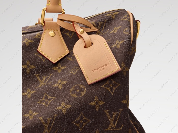 Close-up of Louis Vuitton Silk Tech Monogram bag showing water-repellent droplet texture and leather tag