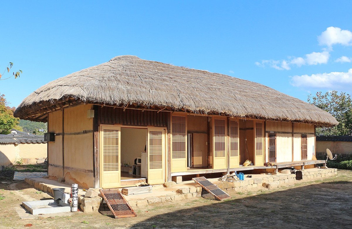 Thatched-roof house with wooden lattice doors in Andong Hahoe Folk Village, a UNESCO World Heritage village