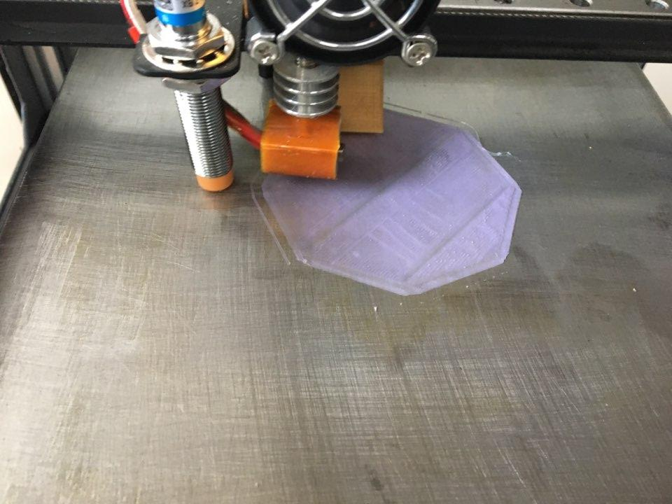 3D프린터 노즐이 보라색 PLA 필라멘트로 연필꽂이 바닥면을 출력하는 초기 단계