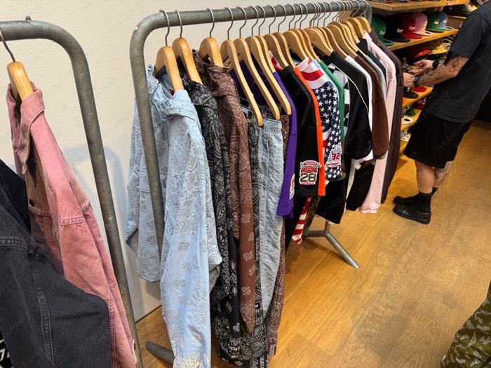 ⁠A rack of colorful Supreme jackets and shirts on hangers inside the Paris store during season off⁠